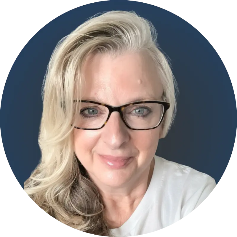 Victoria Smith, MD is a certified life coach for neurodiversity who specializes in supporting neurodiverse individuals and their families. She has blond hair, blue eyes and is wearing glasses.